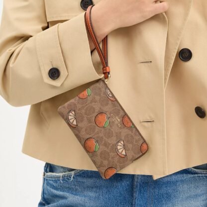 Bolso de mano con cremallera en las esquinas, de lona distintiva y estampado naranja - Imagen 2